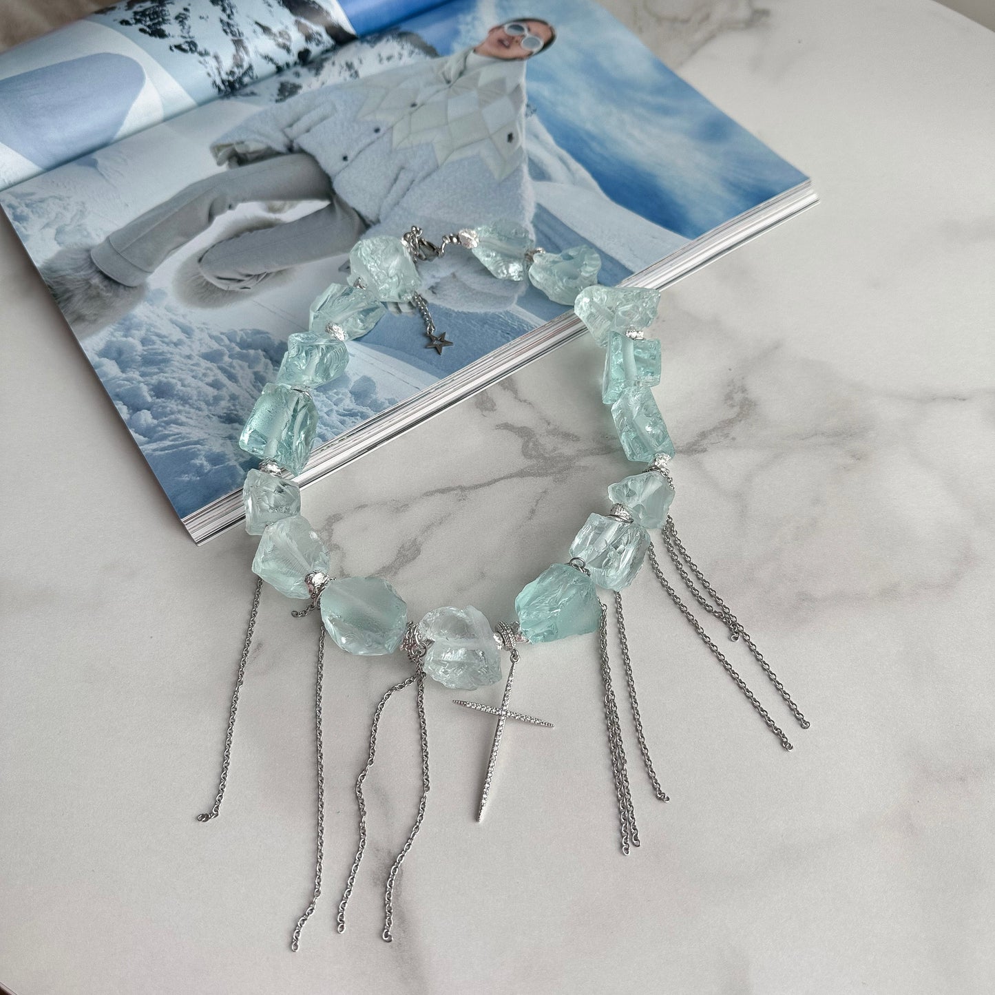 Unusual necklace with raw aquamarine beads, cross and chains