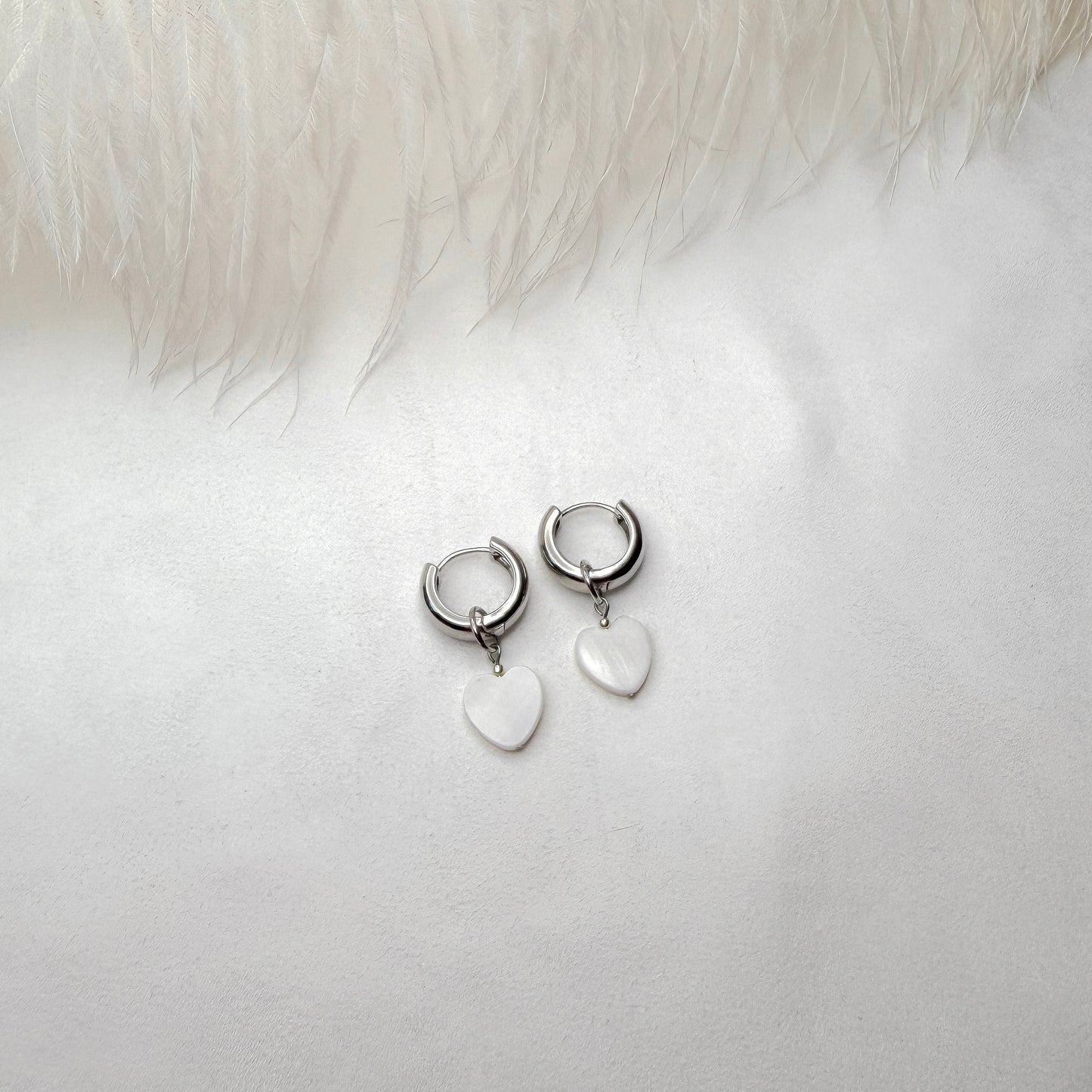 Hoop earrings with interchangeable heart pendants