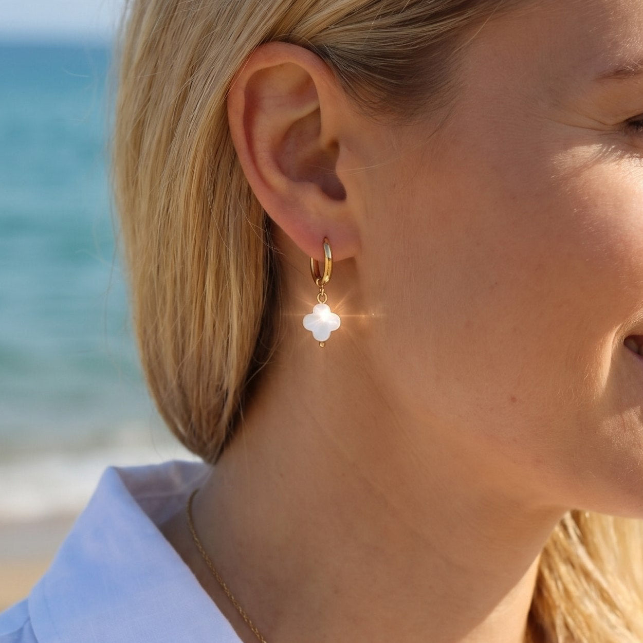 Earrings with mother of pearl clover pendants