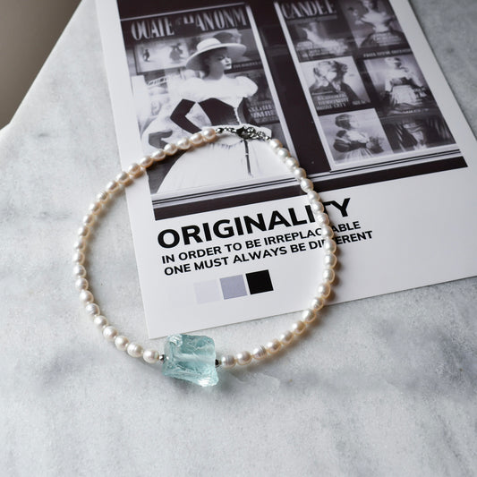 Pearl necklace with raw blue crystal