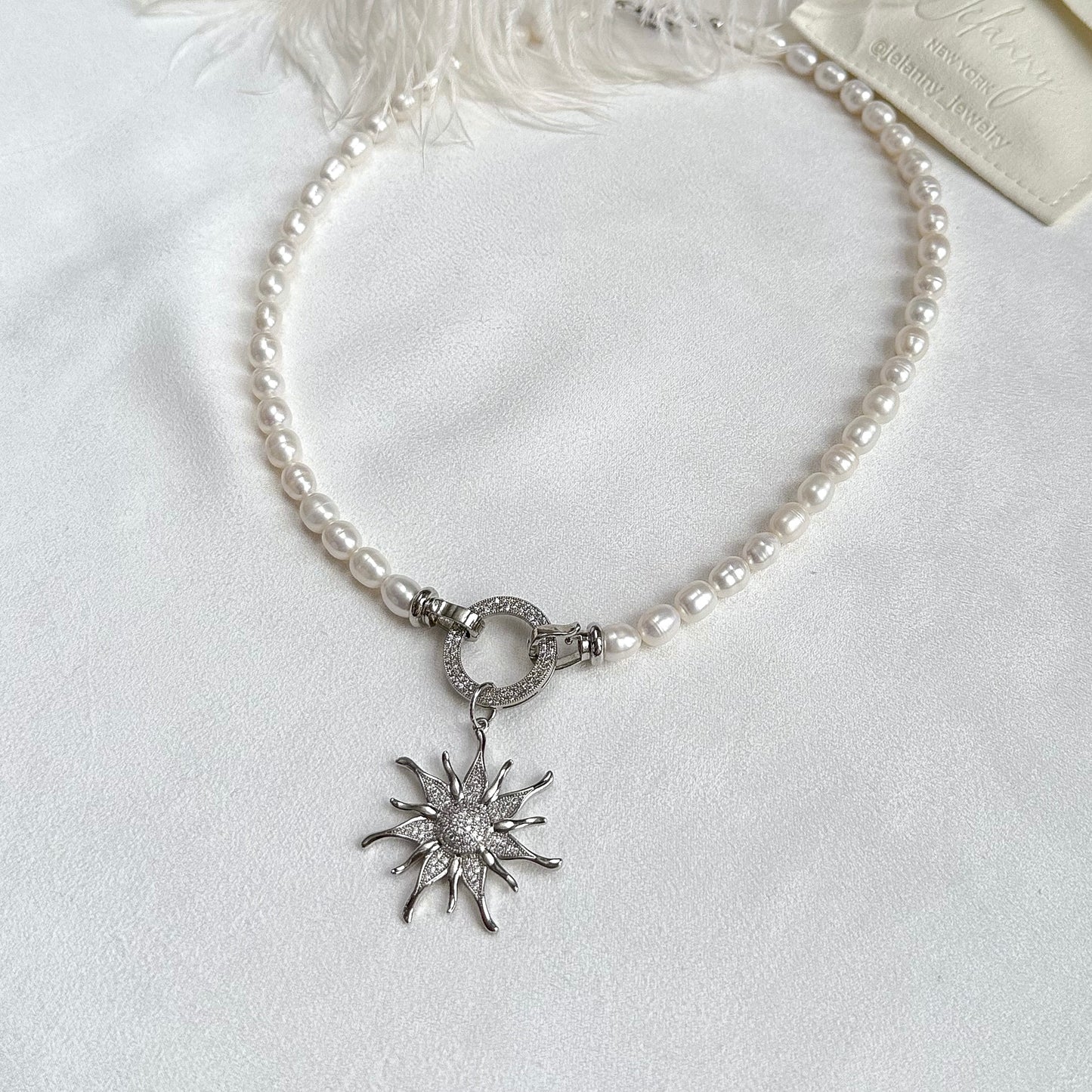 Necklace with sunburst pendant