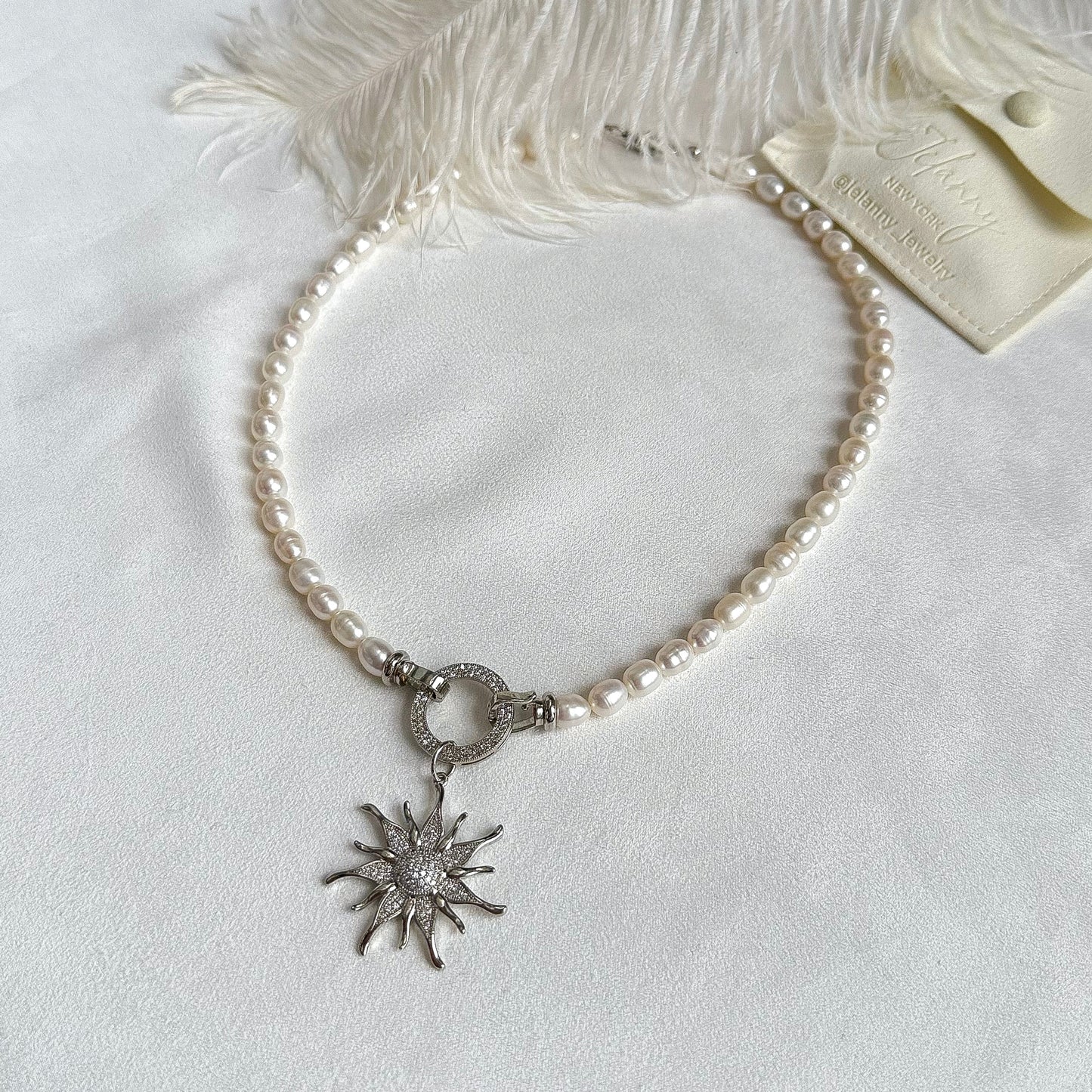 Necklace with sunburst pendant