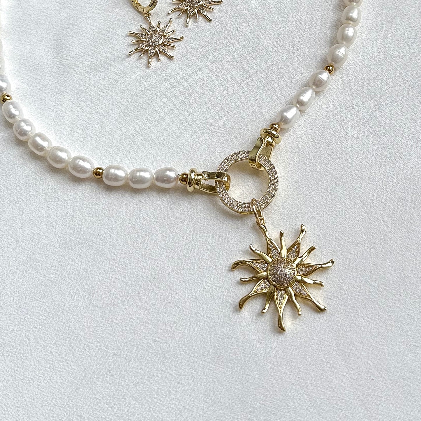 Necklace with sunburst pendant