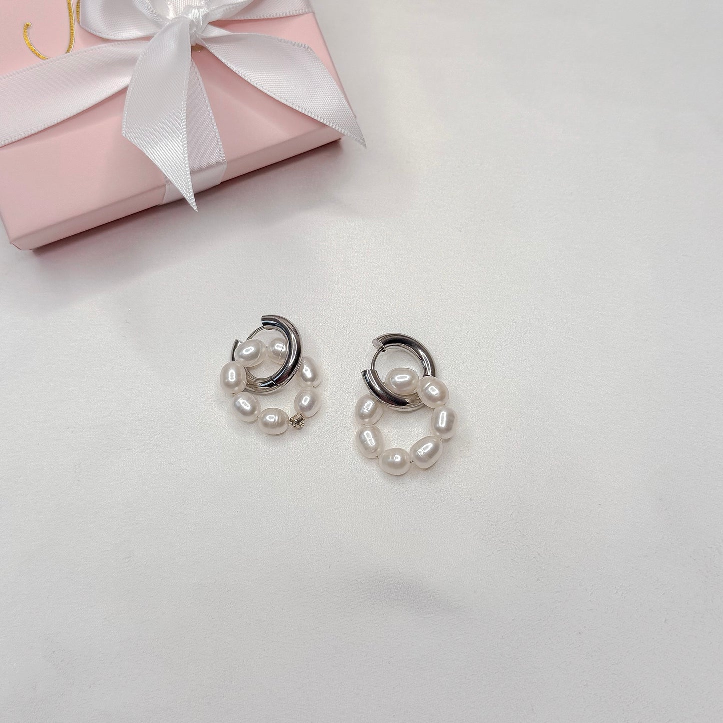 pearl hoop earrings interchangeable charms close up product photo