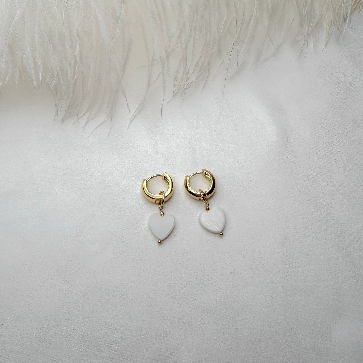 Hoop earrings with interchangeable heart pendants