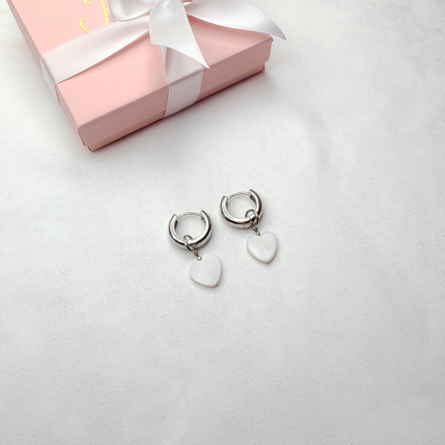 Hoop earrings with interchangeable heart pendants